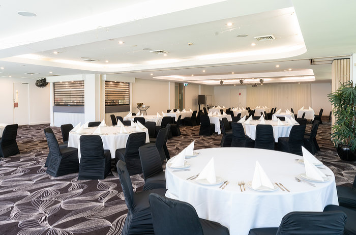 Round tables set up for a formal business function at Sharks at Kareela Sutherland Shire